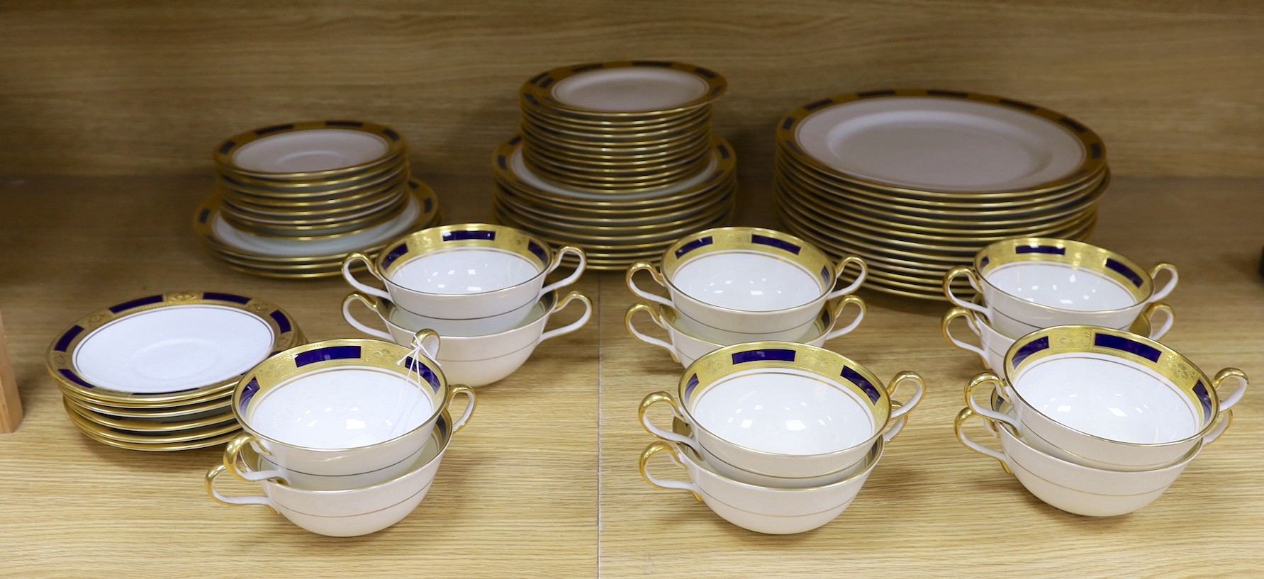 An Aynsley blue and gilt part dinner service